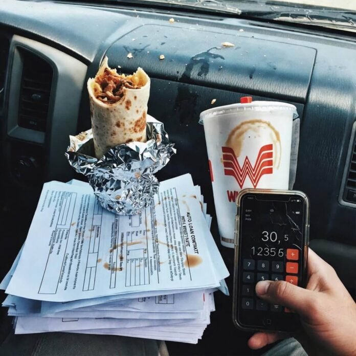 Messy Tacoma dash with burrito and stained loan papers.